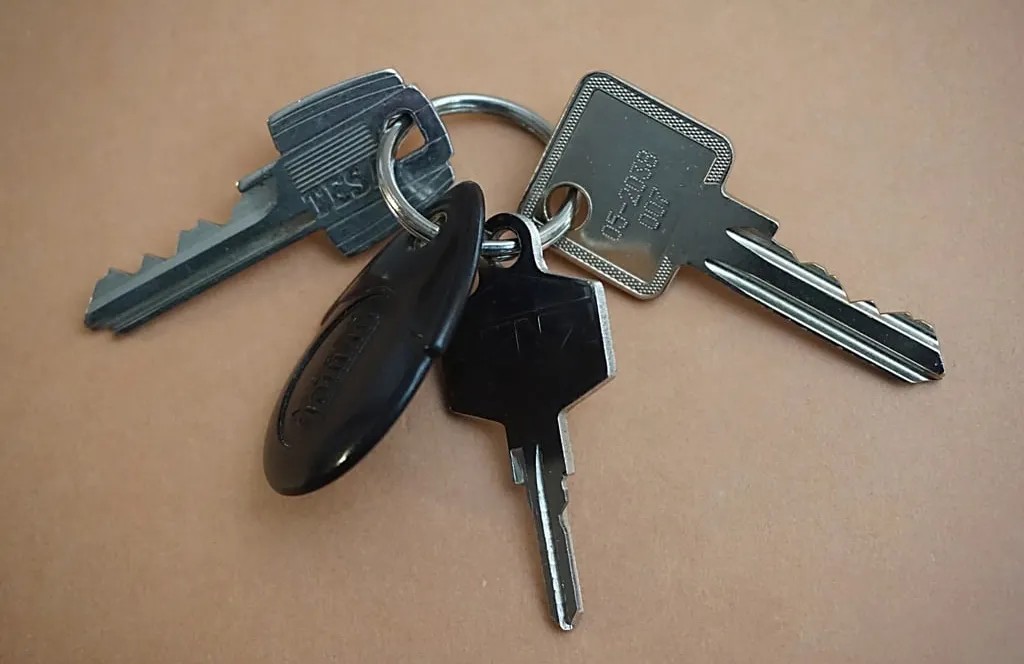 A bunch of house keys lying on a table