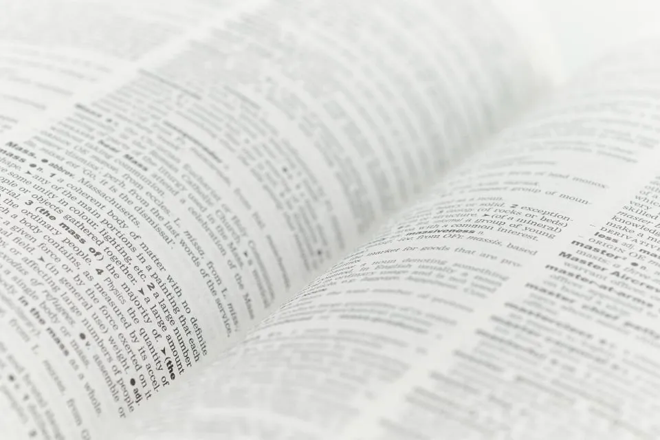 A notebook of Spanish vocabulary and a cup of coffee on a cafe table