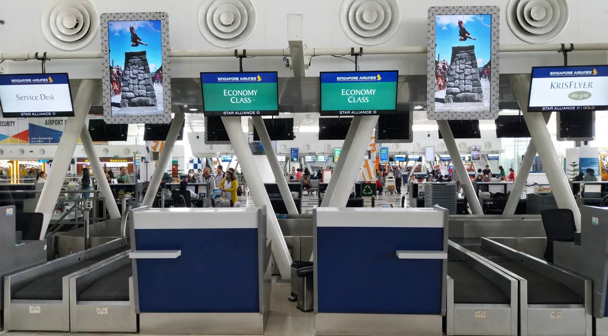 A row of turnstiles in an airport terminal