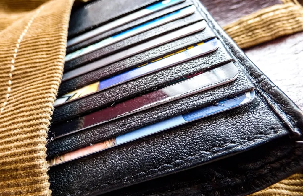 Bank cards slotted into the compartments of a leather wallet