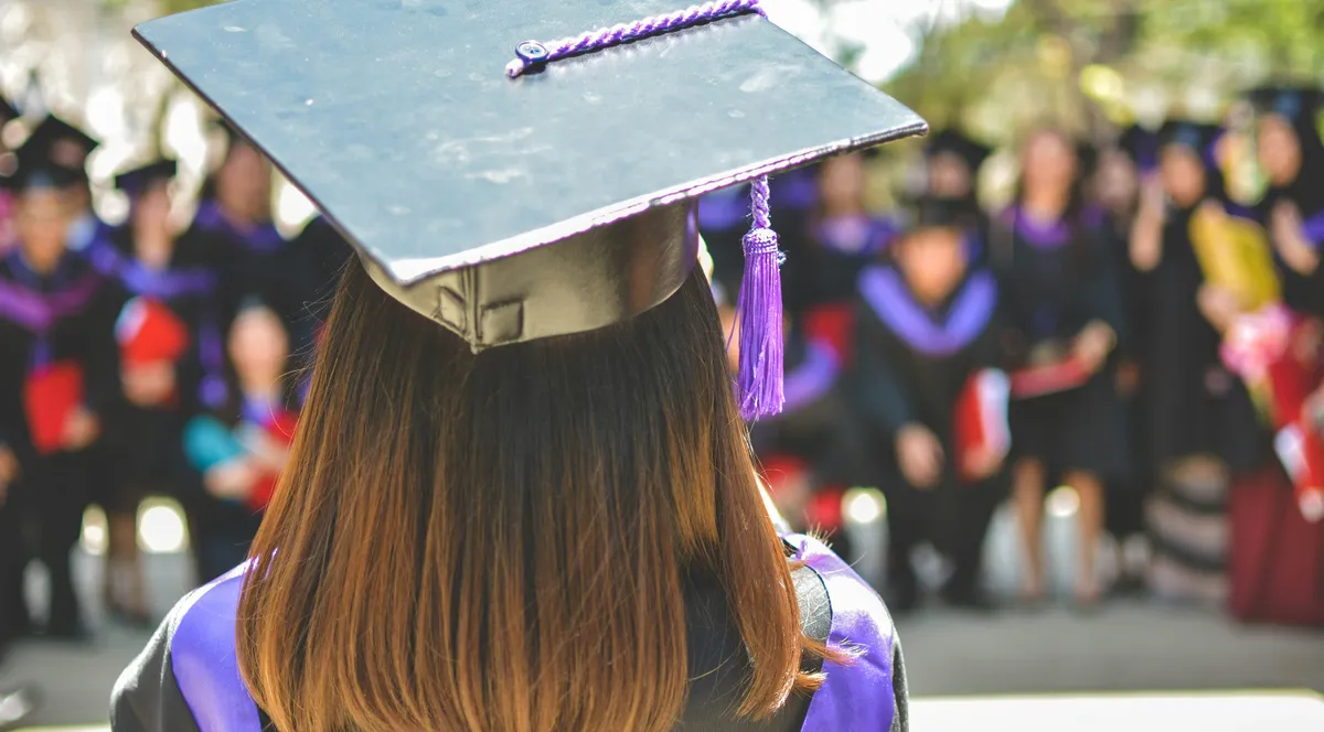 A graduate wearing a cap and gown